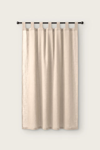 2-layer muslin cotton curtain panel in beige, single tab top panel on a black rod, front view