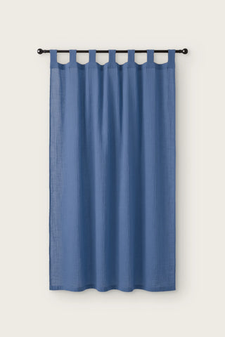 2-layer muslin cotton curtain panel in blue, single tab top panel on a black rod, front view