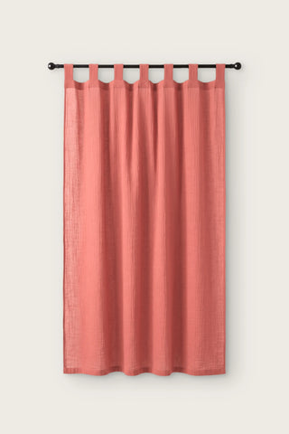 2-layer muslin cotton curtain panel in coral, single tab top panel on a black rod, front view