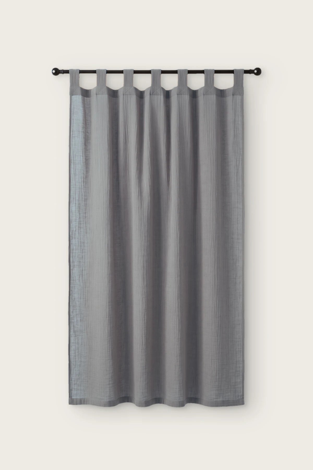 2-layer muslin cotton curtain panel in gray, single tab top panel on a black rod, front view