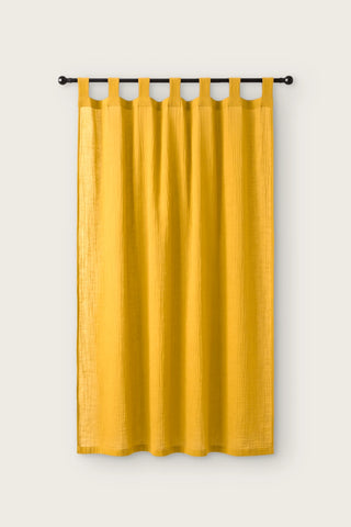 2-layer muslin cotton curtain panel in yellow, single tab top panel on a black rod, front view
