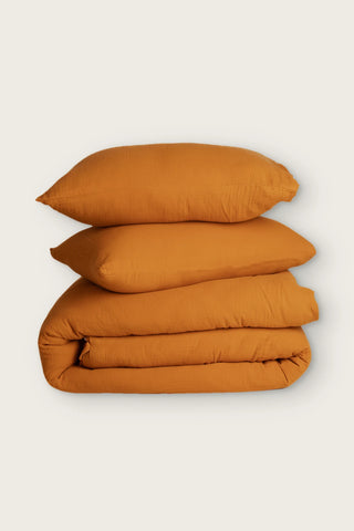Crinkle muslin Turkish cotton duvet cover set in caramel, folded duvet with two pillowcases, front view