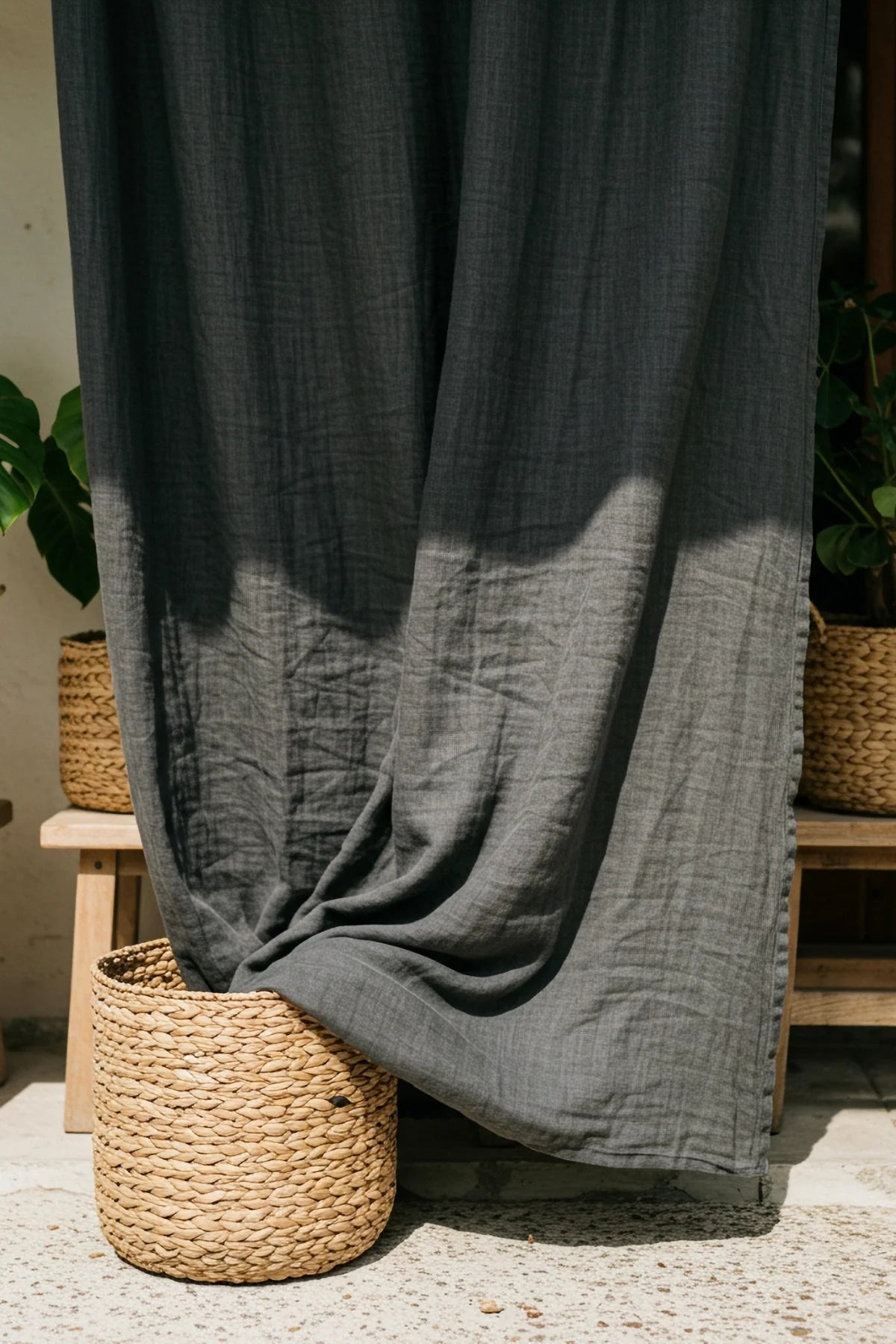 Gray panel draped into basket, outdoor patio. Handwoven 2-layer muslin cotton curtain, Denizli, OEKO-TEX. Vivamaison.