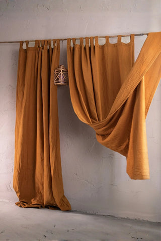 Camel panels draped on rod with lantern. Handwoven 2-layer muslin cotton curtain, Denizli, OEKO-TEX. Vivamaison.