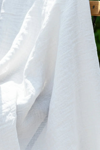 Sheer white gauze texture closeup outdoors. Handwoven 2-layer muslin cotton curtain, Denizli, OEKO-TEX. Vivamaison.