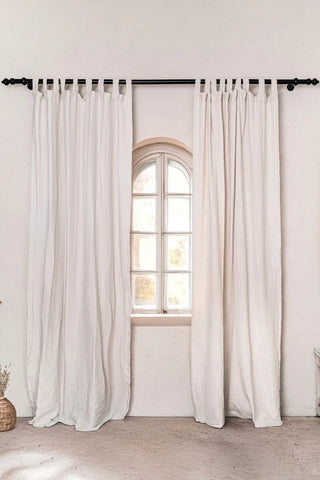 White tab top panels, arched window, black rod. Handwoven 2-layer muslin cotton curtain, Denizli, OEKO-TEX. Vivamaison.