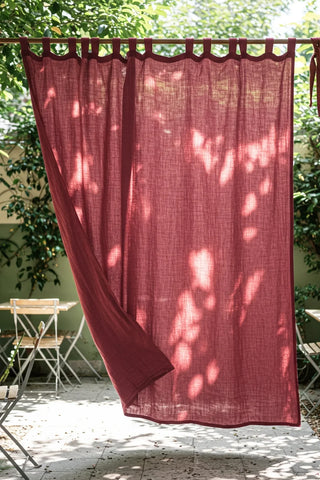 Tab top panels on rod in sunny courtyard. Handwoven 2-layer muslin cotton curtain, Denizli, OEKO-TEX. Vivamaison.