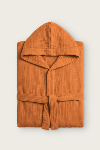 Handwoven 2-layer muslin hooded bathrobe in dark tile, folded front view with hood and tied belt