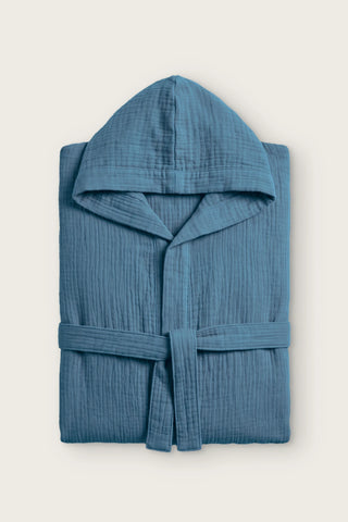 Handwoven 2-layer muslin hooded bathrobe in indigo blue, folded front view with hood and tied belt