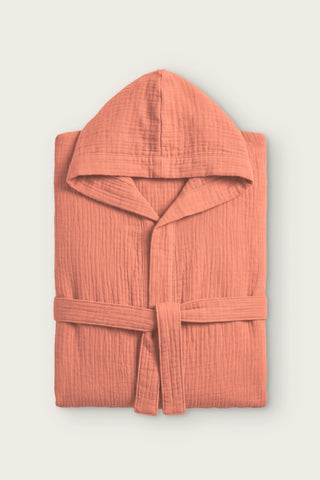 Handwoven 2-layer muslin hooded bathrobe in terracotta, folded front view with hood and tied belt