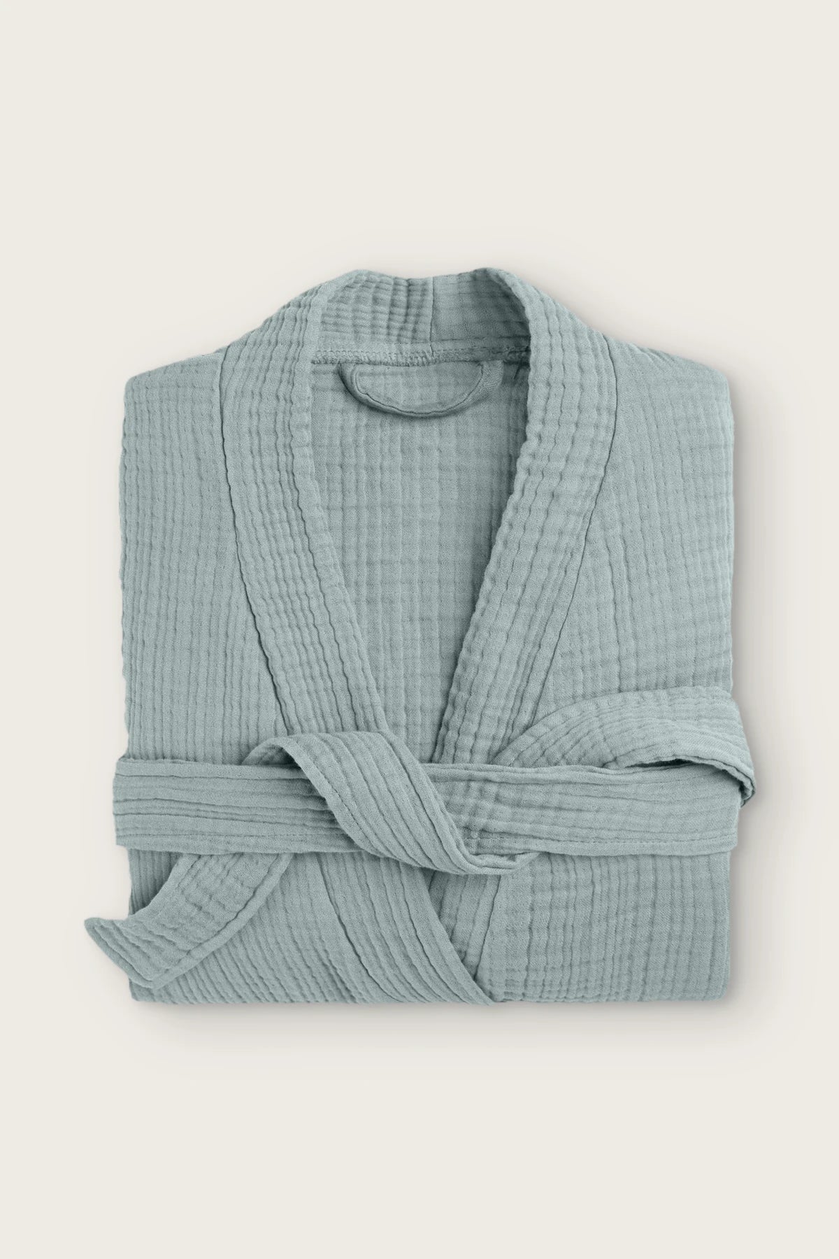 Handwoven 4-layer muslin kimono bathrobe in sage green, folded front view with wrapped belt
