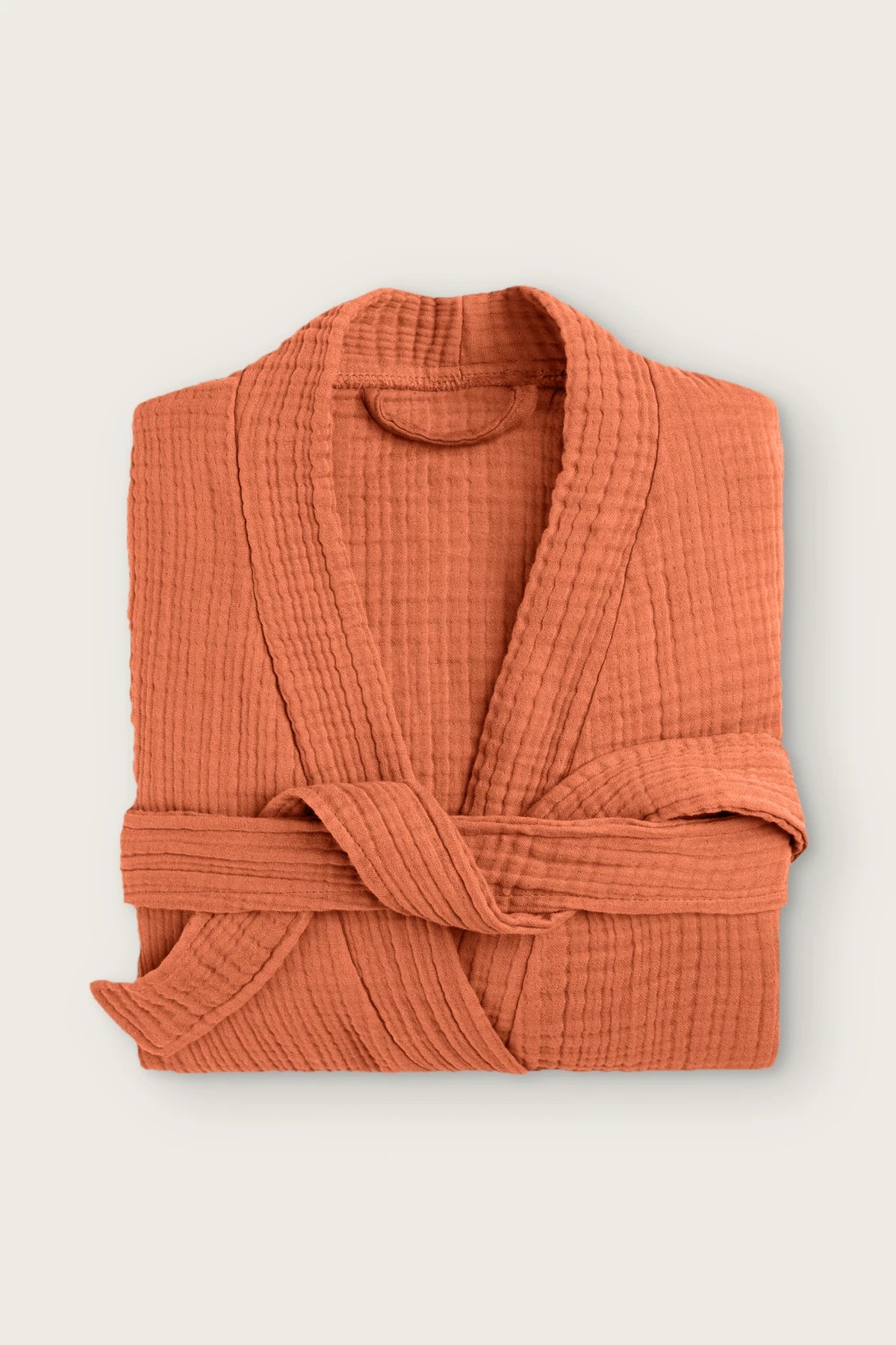Handwoven 4-layer muslin kimono bathrobe in terracotta, folded front view with wrapped belt