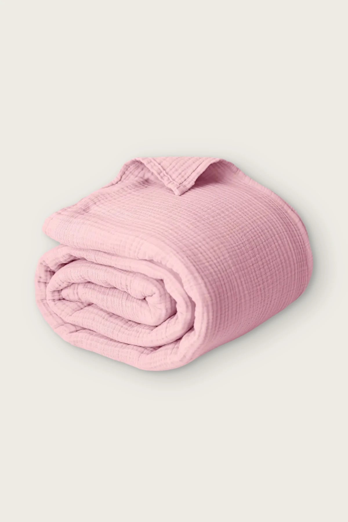 Handwoven 4-layer muslin cotton bedspread in pink, rolled front view