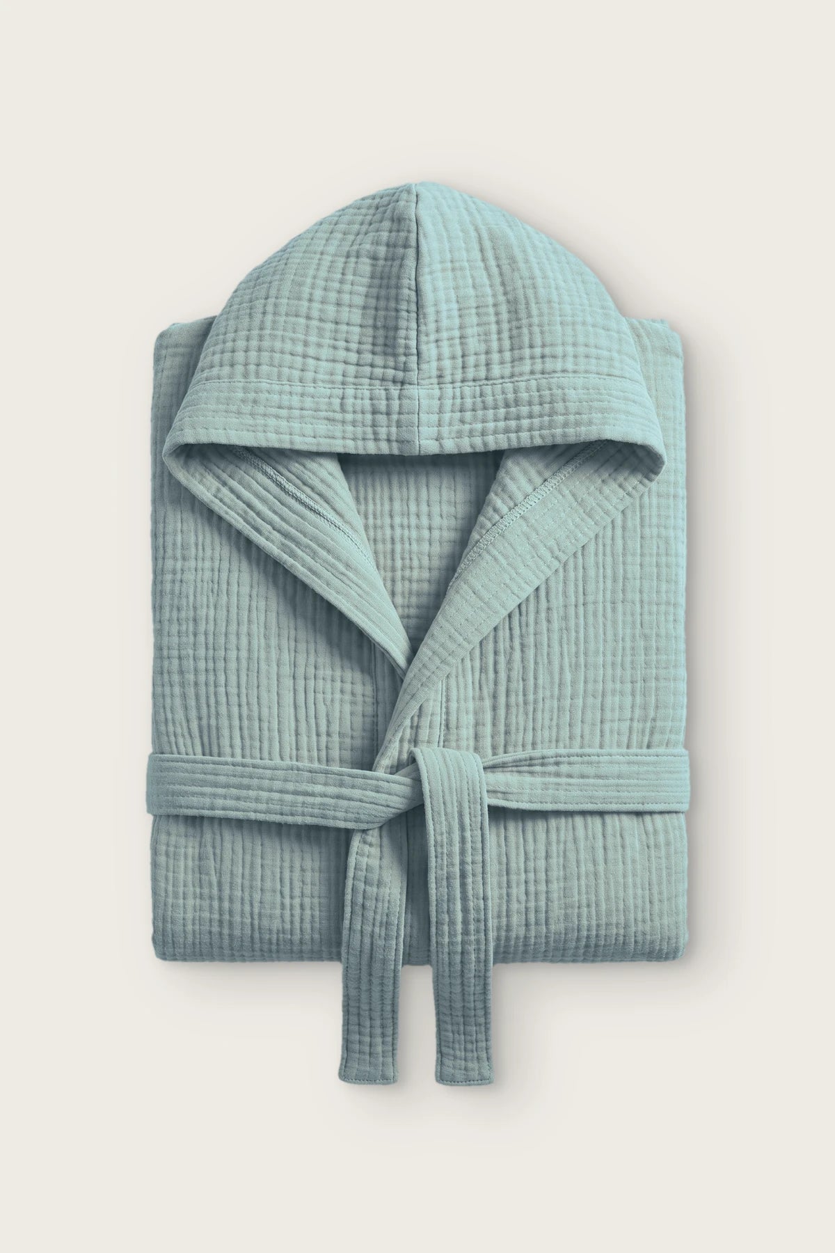Handwoven 4-layer muslin hooded bathrobe in sage green, folded front view with hood and tied belt