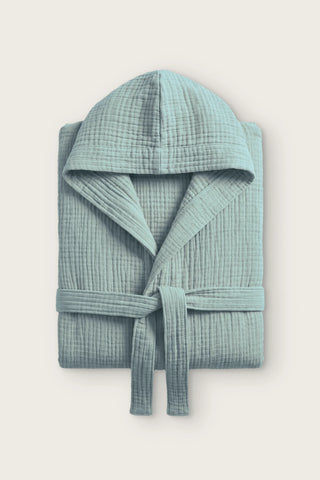 Handwoven 4-layer muslin hooded bathrobe in sage green, folded front view with hood and tied belt