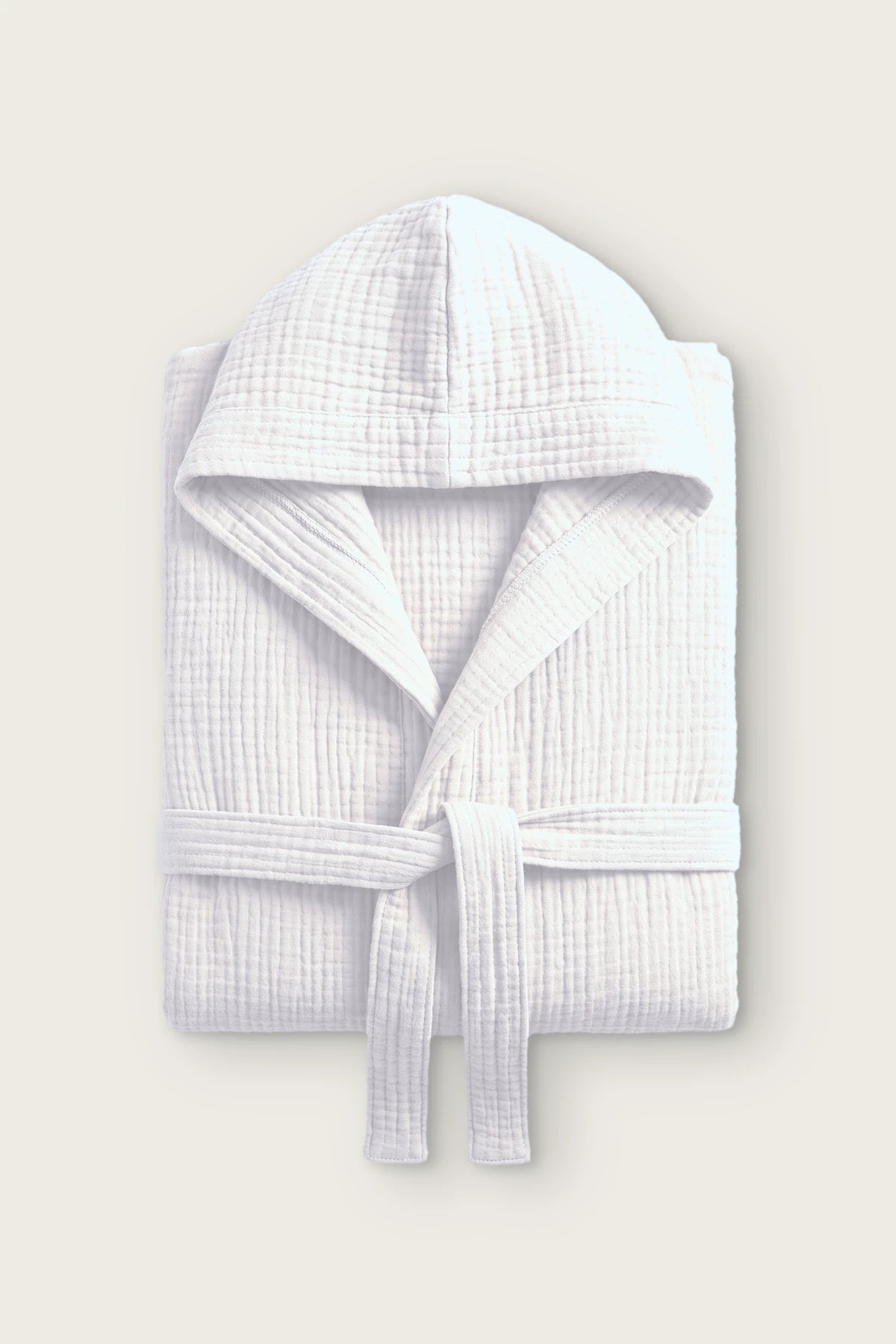 Handwoven 4-layer muslin hooded bathrobe in white, folded front view with hood and tied belt