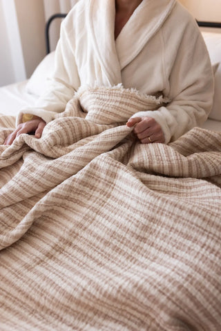 Latte Striped handwoven 8-layer muslin Turkish cotton quilt bedroom lifestyle. Hand-tied fringe Denizli, OEKO-TEX. Vivamaison
