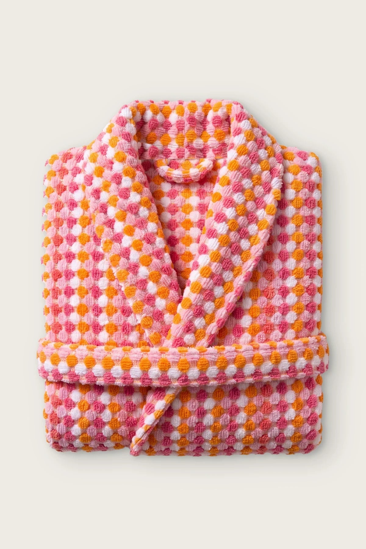 Handwoven bobble cotton hooded bathrobe in pink orange, folded front view with shawl collar and belt