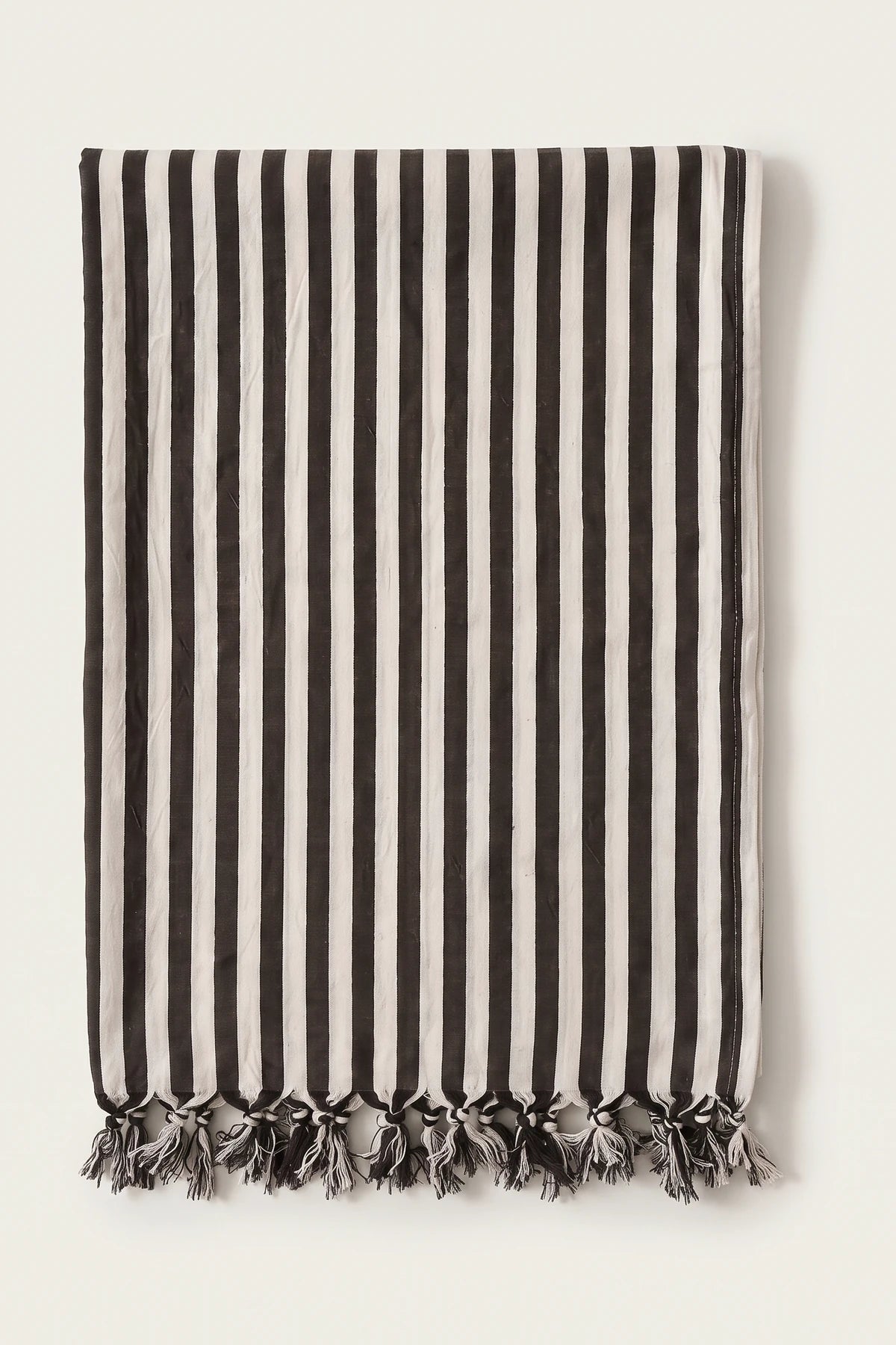 Classic striped Turkish cotton peshtemal towel in black, folded front view with knotted fringe
