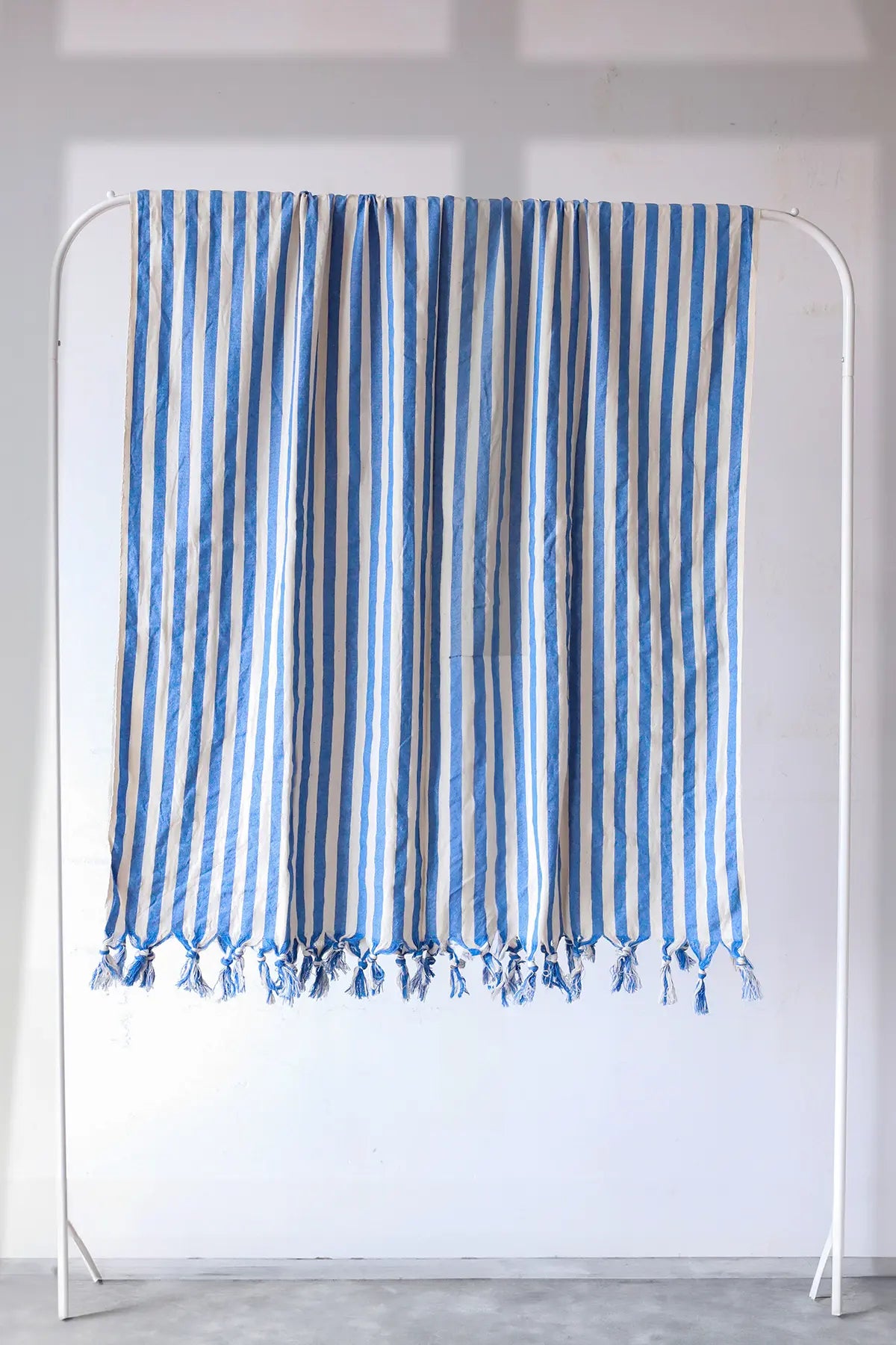 Blue classic striped peshtemal towel hanging full view. Handwoven Turkish cotton Denizli, OEKO-TEX. Vivamaison.