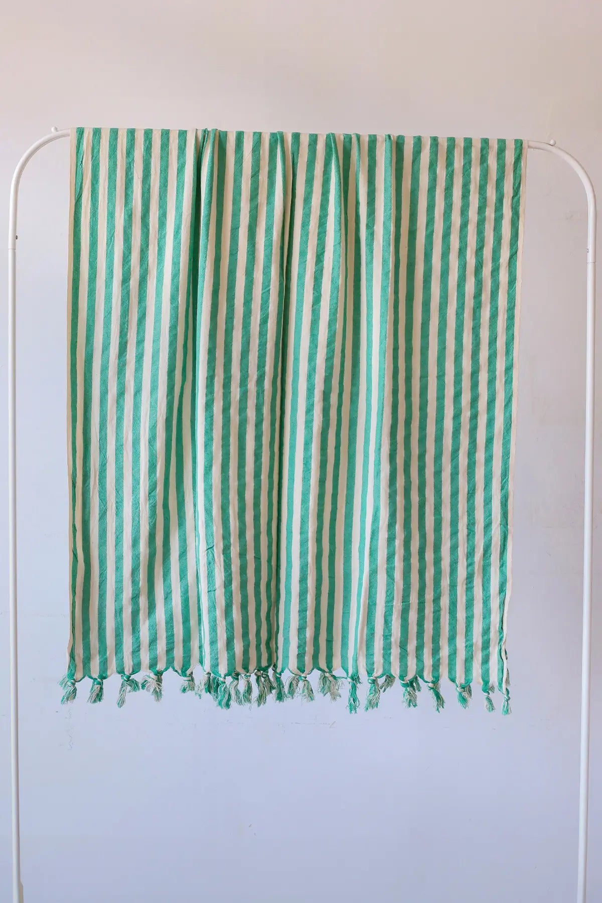 Green classic striped peshtemal towel hanging full view. Handwoven Turkish cotton Denizli, OEKO-TEX. Vivamaison.