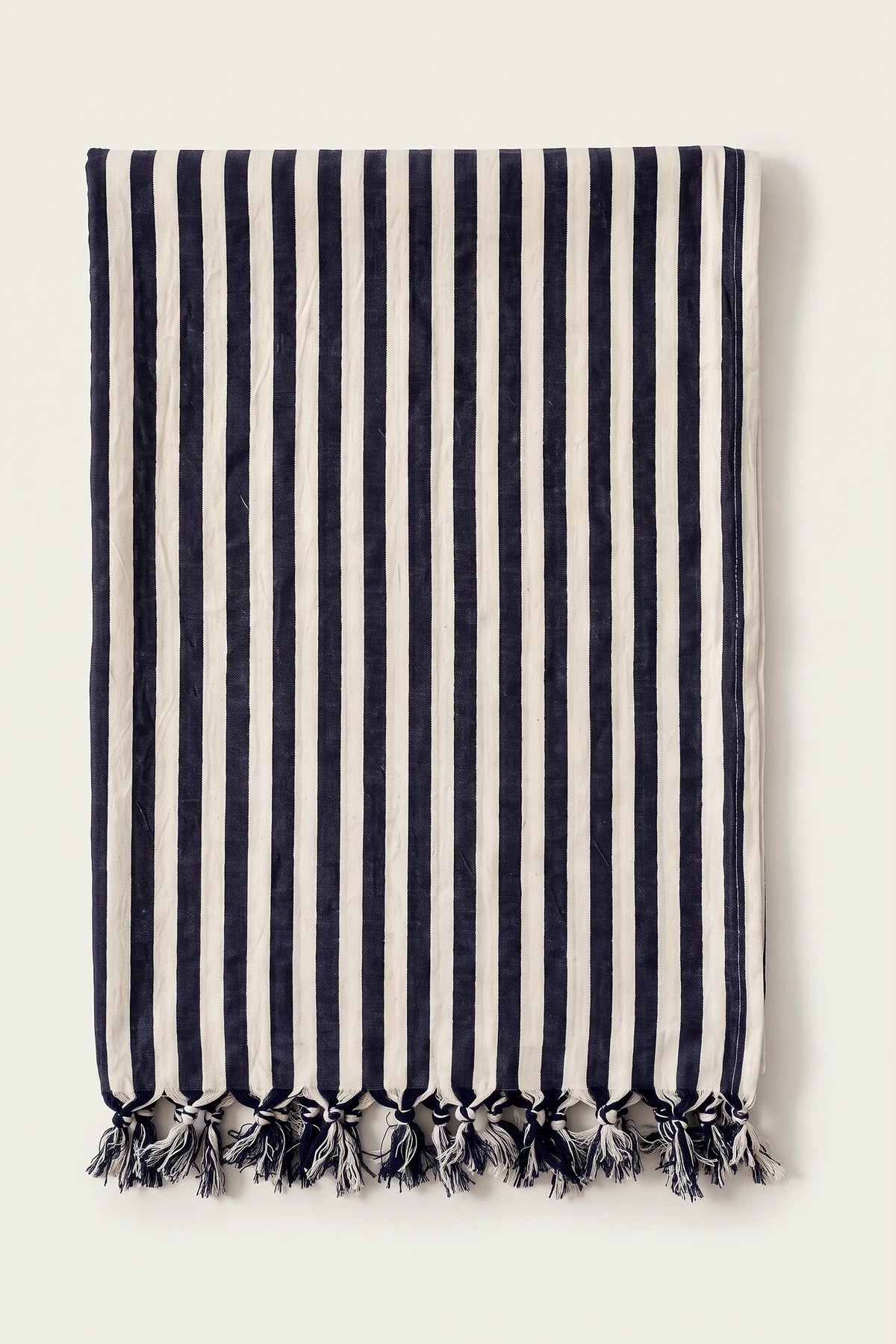 Classic striped Turkish cotton peshtemal towel in navy blue, folded front view with knotted fringe