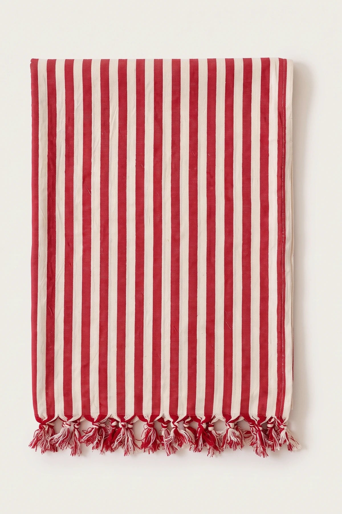 Classic striped Turkish cotton peshtemal towel in red, folded front view with knotted fringe