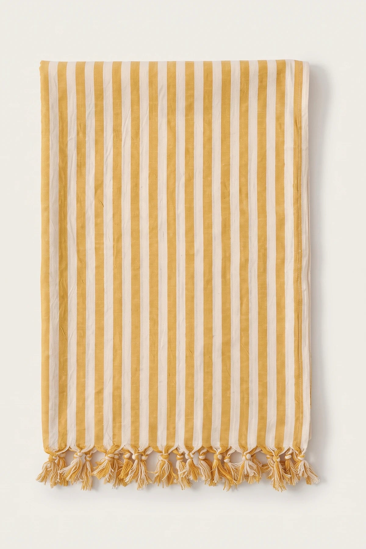 Classic striped Turkish cotton peshtemal towel in yellow, folded front view with knotted fringe
