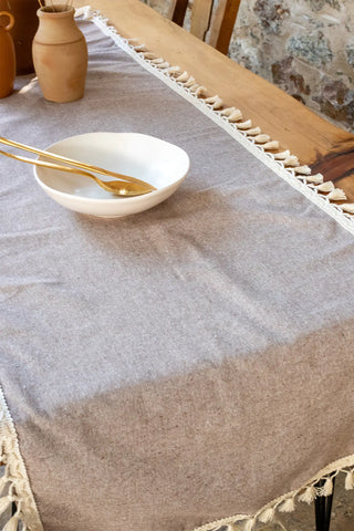 Brown handwoven Turkish cotton tassel table runner folded flat lay. Hand-tied tassels Denizli, OEKO-TEX. Vivamaison.