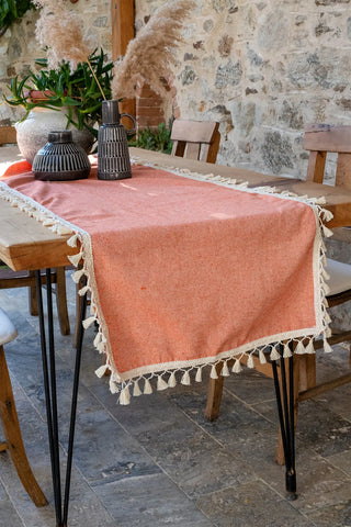 Orange handwoven Turkish cotton tassel table runner folded flat lay. Hand-tied tassels Denizli, OEKO-TEX. Vivamaison.