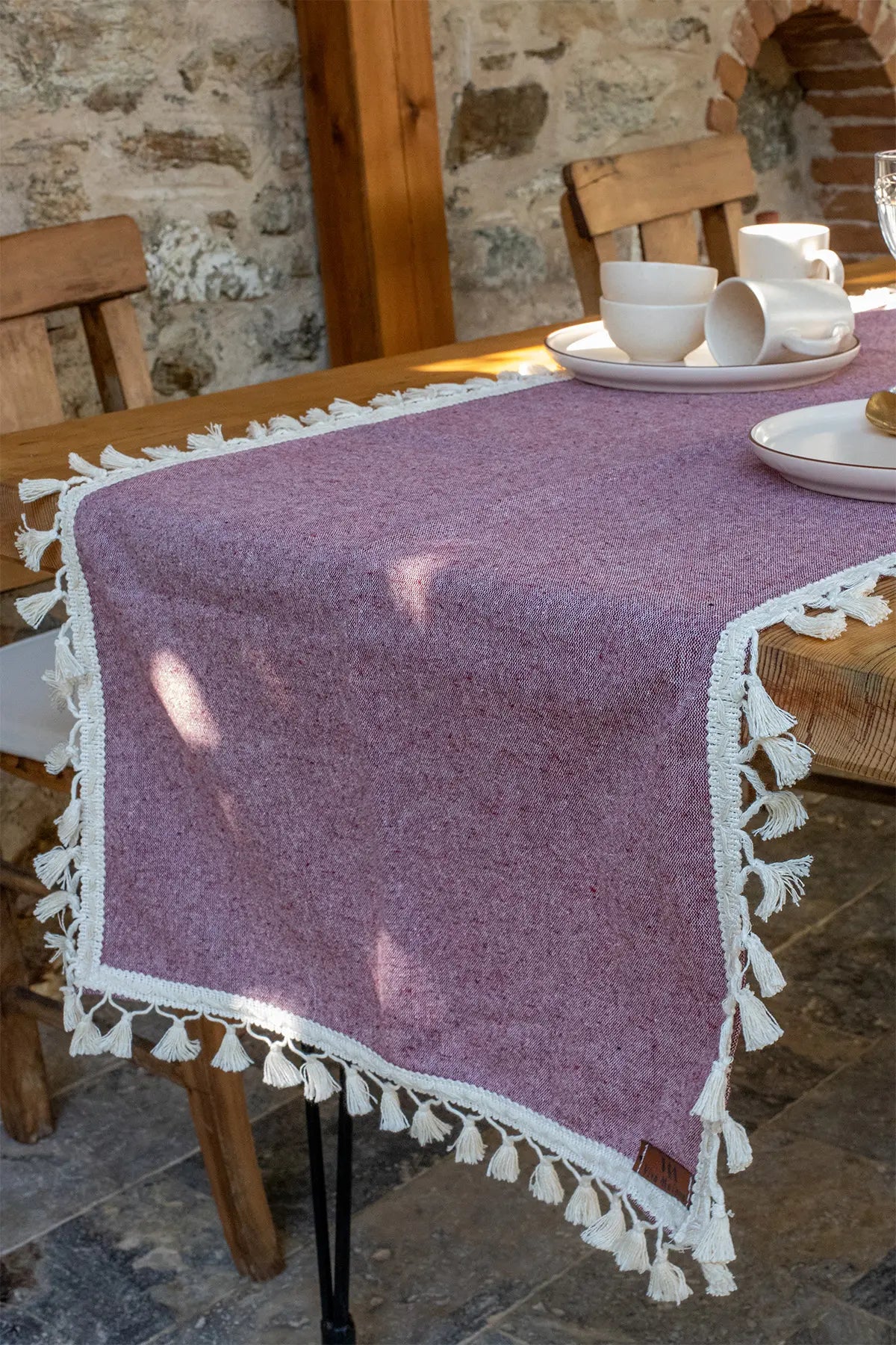 Plum handwoven Turkish cotton tassel table runner folded flat lay. Hand-tied tassels Denizli, OEKO-TEX. Vivamaison.