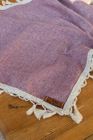 Plum handwoven Turkish cotton tassel table runner overhead. Hand-tied tassels Denizli, OEKO-TEX. Vivamaison.