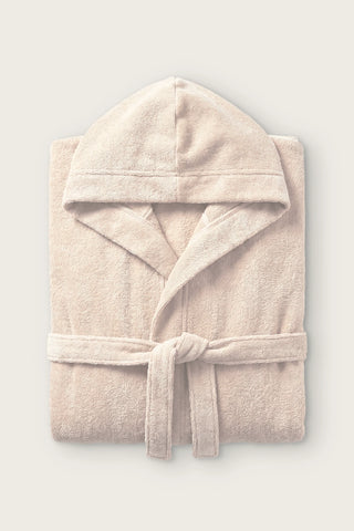 Handwoven Turkish cotton terry hooded bathrobe in beige, folded front view with hood and tied belt