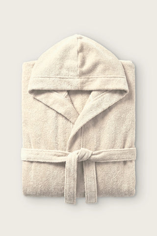 Handwoven Turkish cotton terry hooded bathrobe in cream, folded front view with hood and tied belt