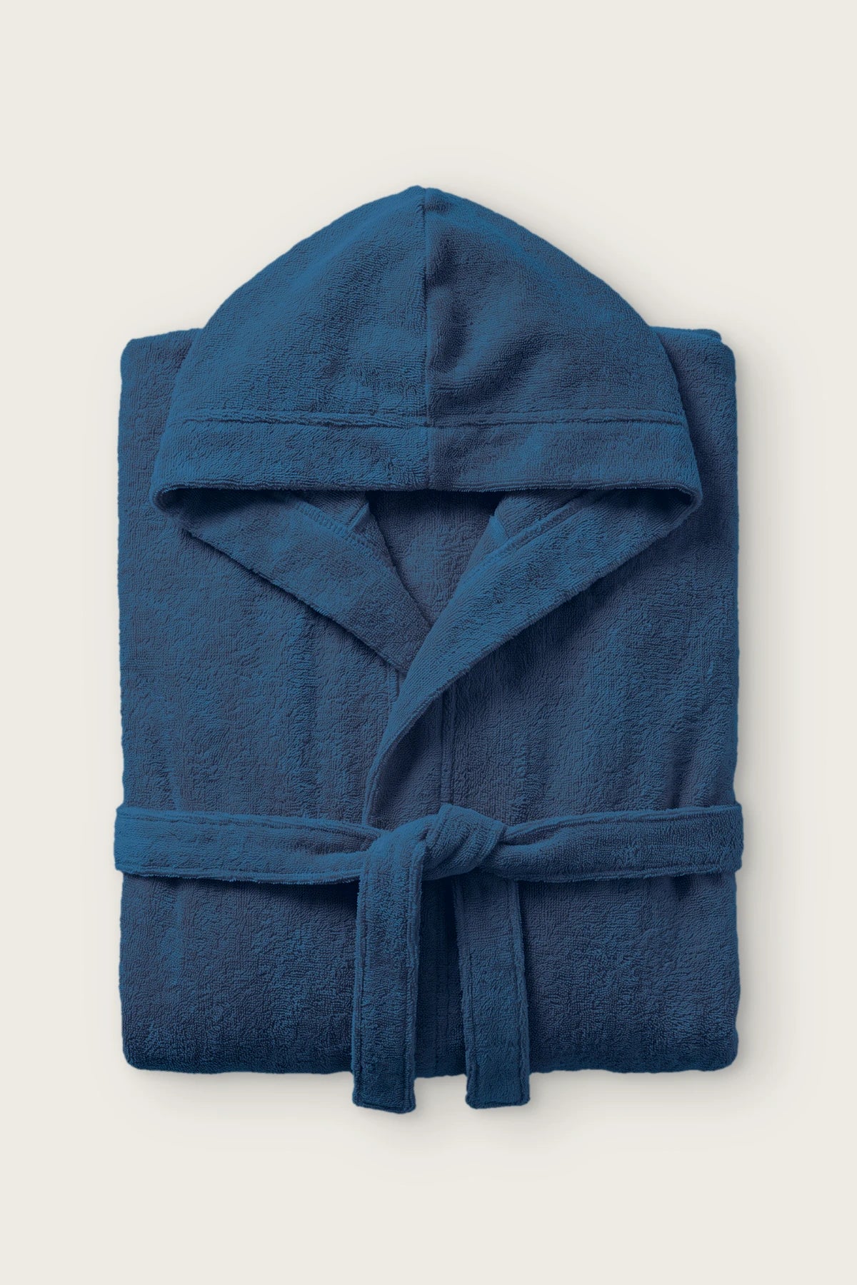 Handwoven Turkish cotton terry hooded bathrobe in indigo blue, folded front view with hood and tied belt