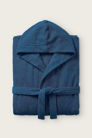 Handwoven Turkish cotton terry hooded bathrobe in indigo blue, folded front view with hood and tied belt