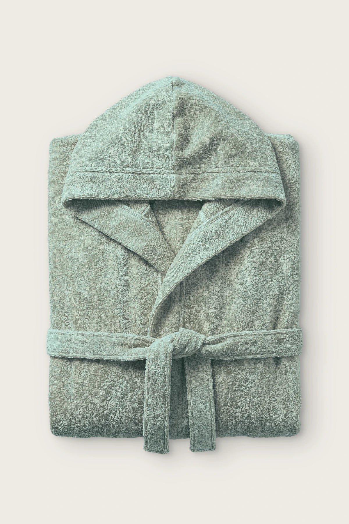 Handwoven Turkish cotton terry hooded bathrobe in sage green, folded front view with hood and tied belt