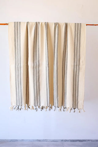 Black elegant striped peshtemal towel hanging full view. Handwoven Turkish cotton Denizli, OEKO-TEX. Vivamaison.
