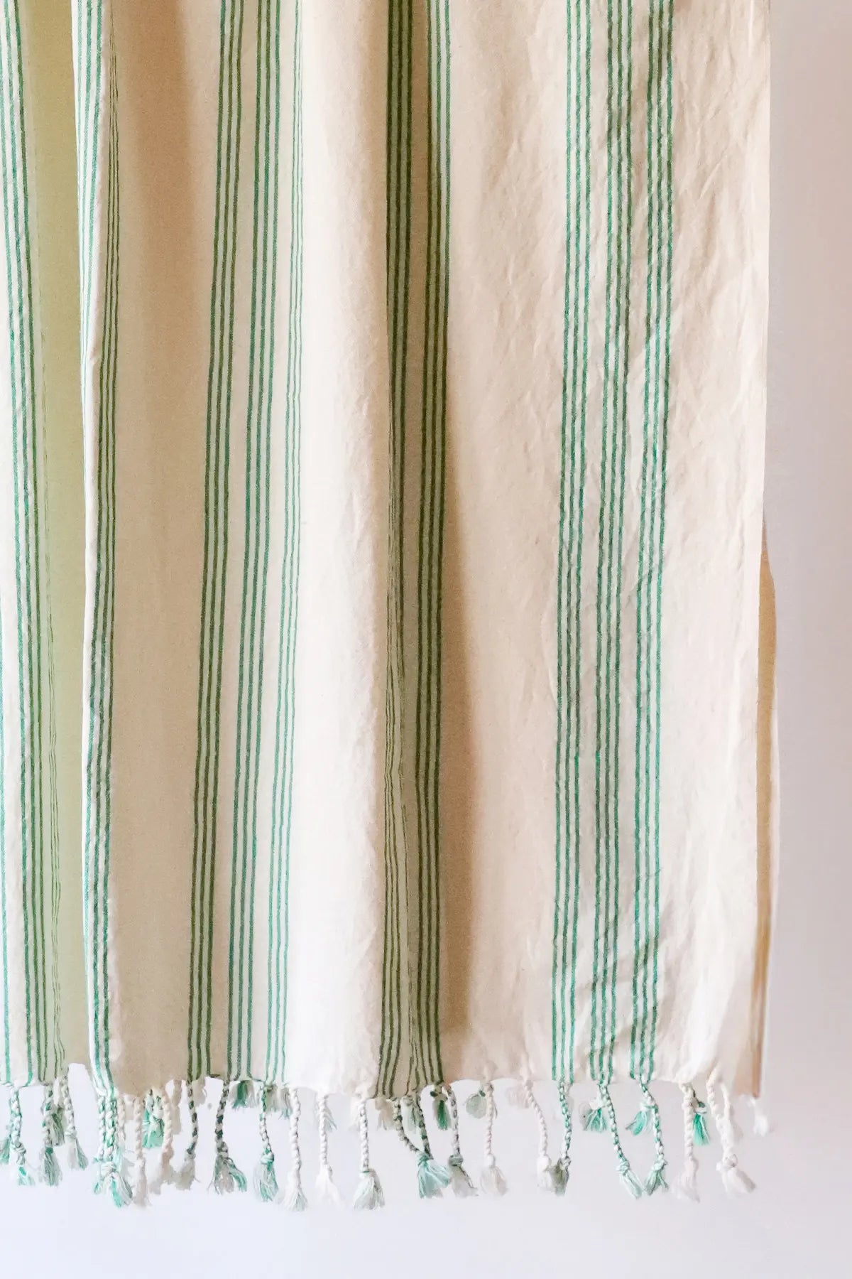 Green elegant striped peshtemal towel fringe detail closeup. Handwoven Turkish cotton Denizli, OEKO-TEX. Vivamaison.