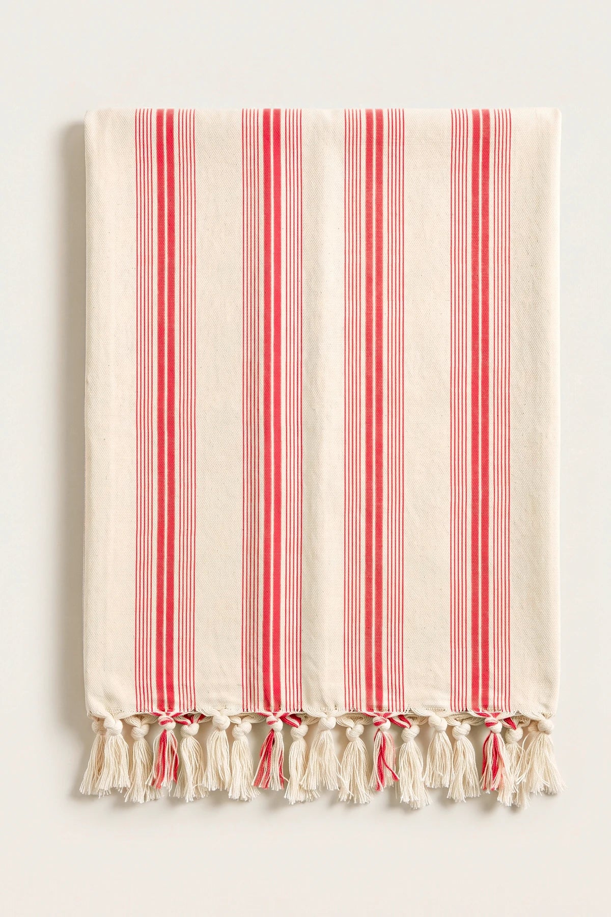 Elegant striped Turkish cotton peshtemal towel in red, folded front view with grouped stripes and knotted fringe