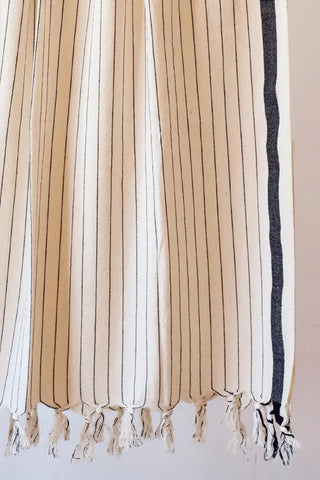 Black luxury striped peshtemal towel fringe detail closeup. Handwoven Turkish cotton Denizli, OEKO-TEX. Vivamaison.