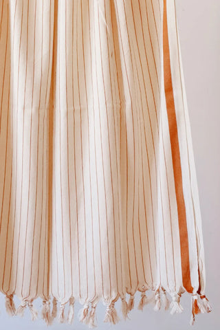 Brown luxury striped peshtemal towel fringe detail closeup. Handwoven Turkish cotton Denizli, OEKO-TEX. Vivamaison.