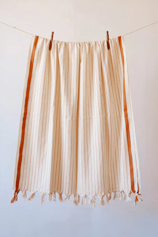 Brown luxury striped peshtemal towel hanging full view. Handwoven Turkish cotton Denizli, OEKO-TEX. Vivamaison.