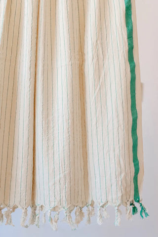 Green luxury striped peshtemal towel fringe detail closeup. Handwoven Turkish cotton Denizli, OEKO-TEX. Vivamaison.
