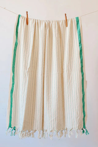 Green luxury striped peshtemal towel hanging full view. Handwoven Turkish cotton Denizli, OEKO-TEX. Vivamaison.