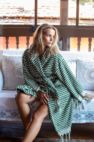 Green white mosaic bathrobe seated front lifestyle. Handwoven Turkish cotton Denizli, OEKO-TEX. Vivamaison.