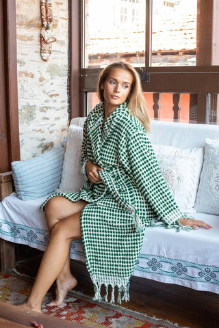 Green white mosaic bathrobe seated side closeup. Handwoven Turkish cotton Denizli, OEKO-TEX. Vivamaison.