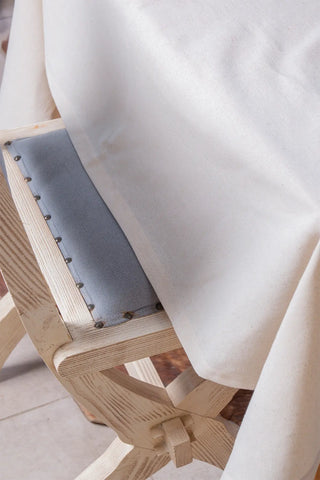 Natural handwoven raw linen plain tablecloth draped detail. Undyed flax Denizli, OEKO-TEX. Vivamaison.