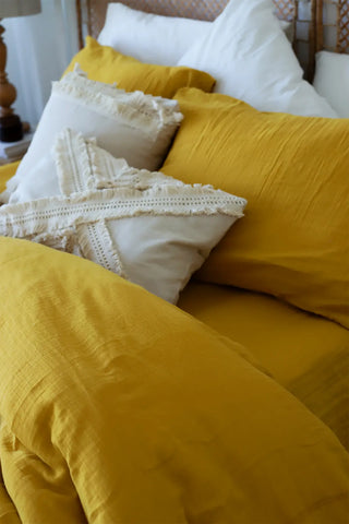 Mustard handwoven soft muslin Turkish cotton plain duvet cover folded flat lay. Long-staple Denizli, OEKO-TEX. Vivamaison.