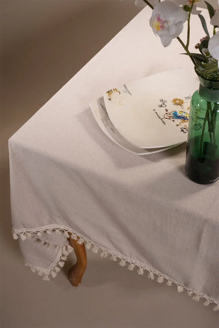 Beige handwoven solid color Turkish cotton tassel tablecloth folded flat lay. Tasseled edges Denizli, OEKO-TEX. Vivamaison.